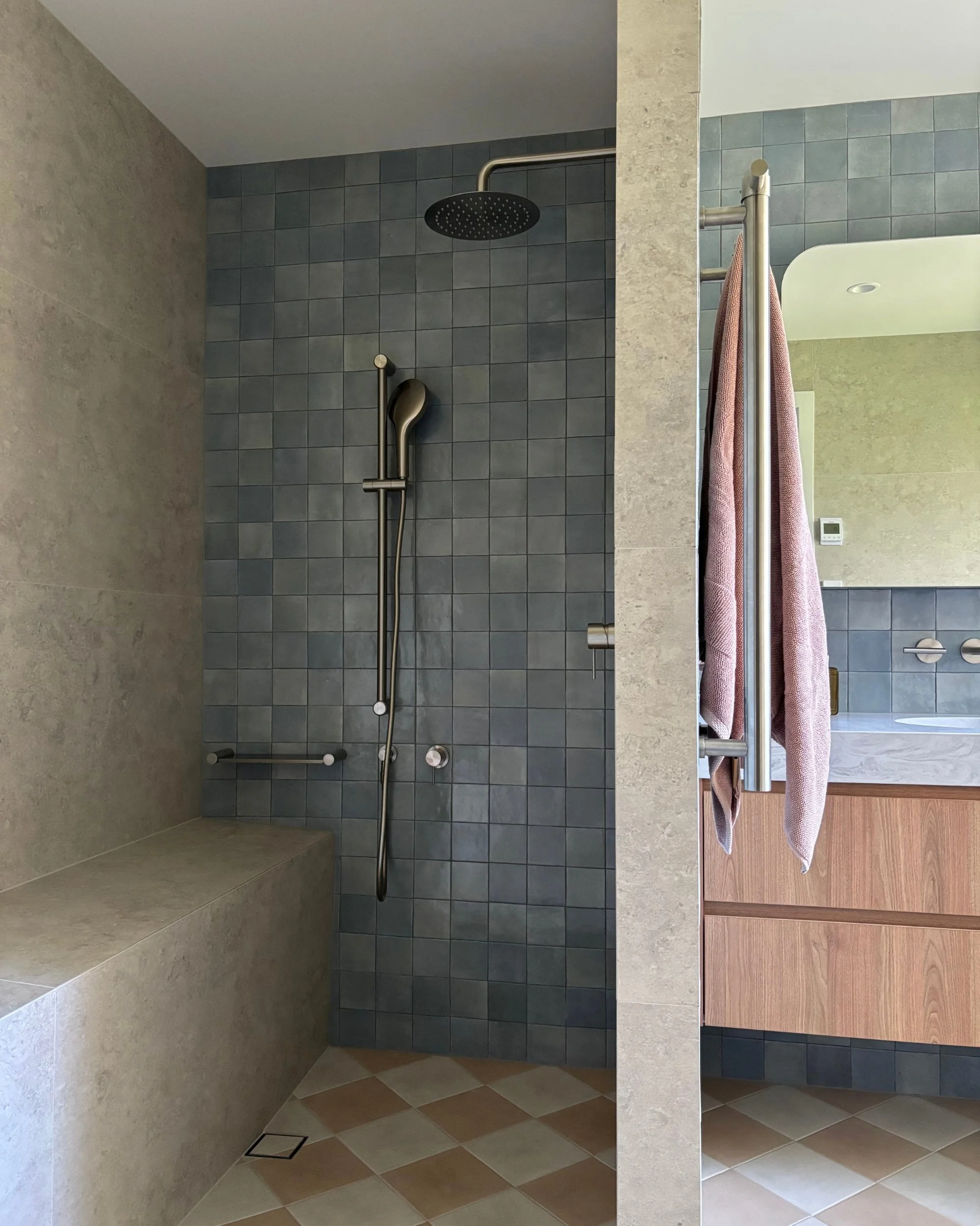 Bathroom layout with walk-in shower, heated tiled bench and custom timber vanity