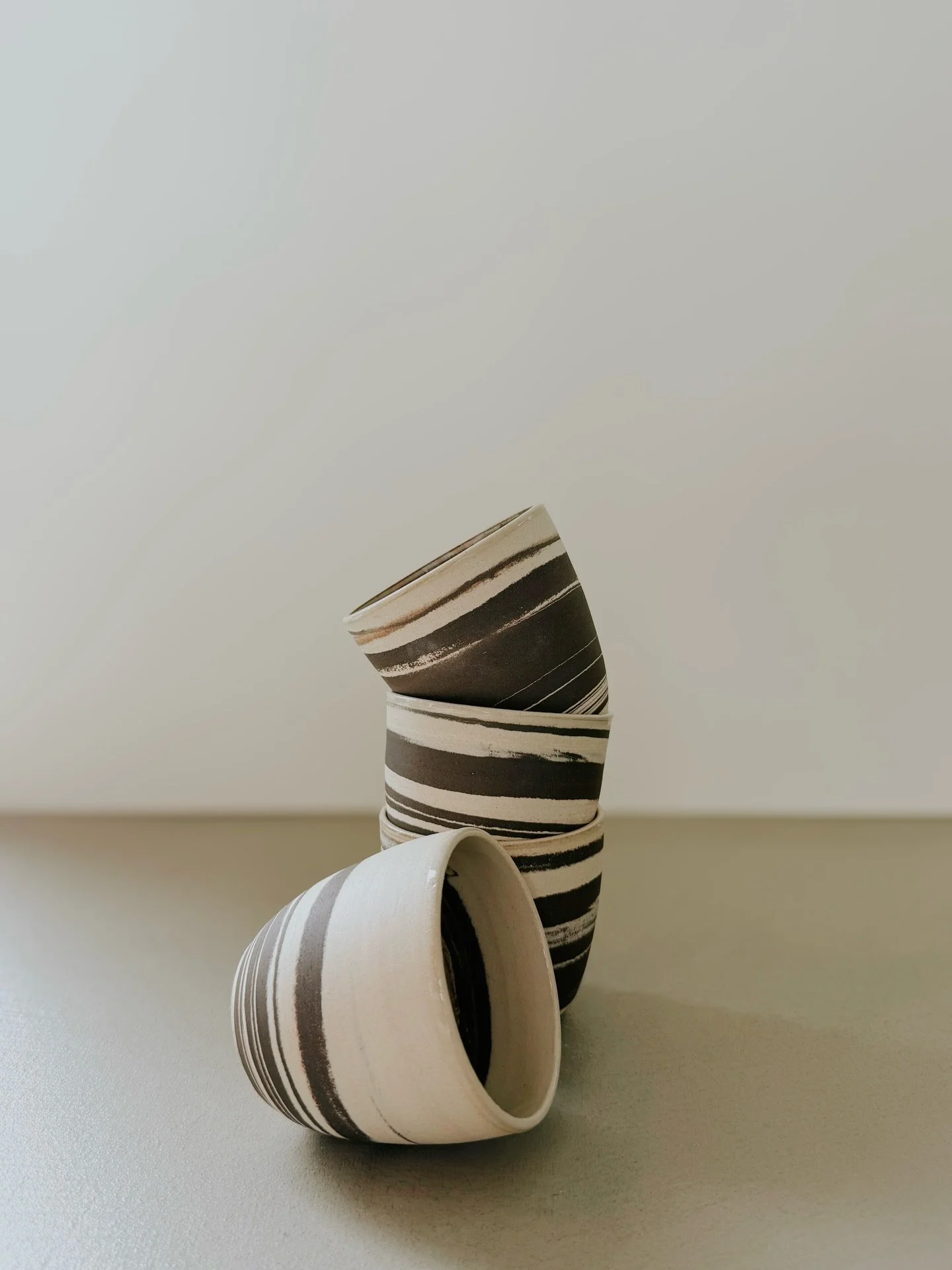 Spiral 

Hand-thrown marbled cup.

Black and neutral clays swirl together in a seamless, one-of-a-kind pattern. Its smooth, rounded shape makes it comfortable to hold and perfect for tea, coffee, or lattes.

7.5 cm high &times; 8 cm wide
Each cup is 