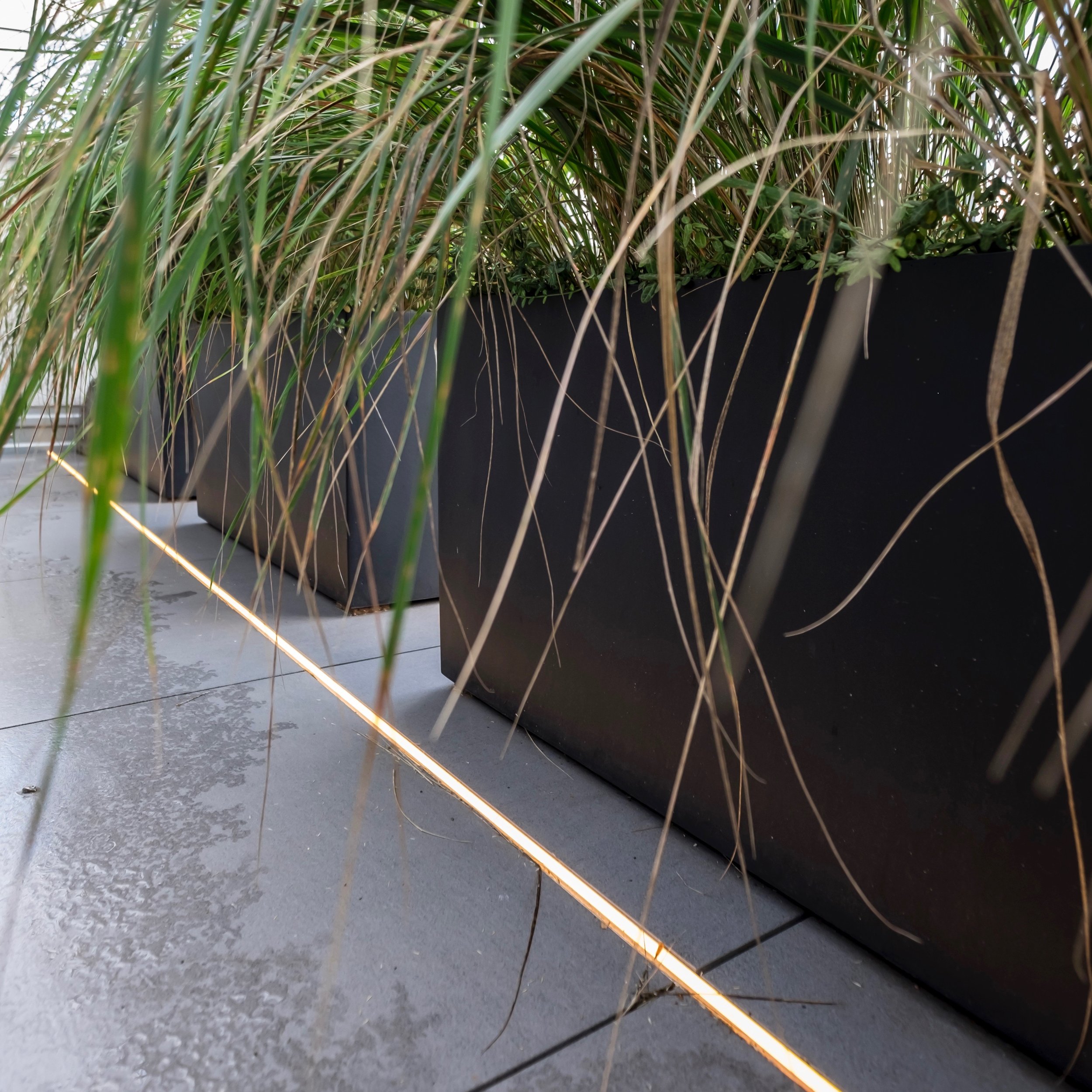 Die Terrasse wird mit wasserdichten LED-Profilen und einer dekorativen Girlande von Viabizzuno beleuchtet.