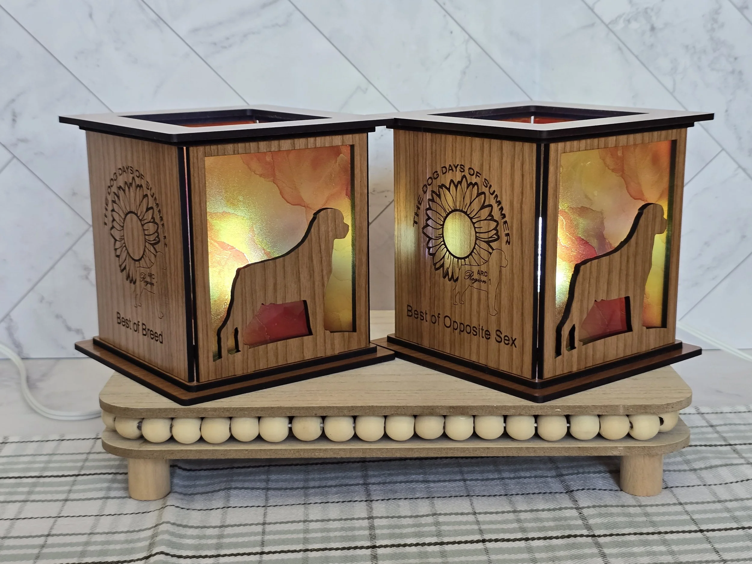 Two lanterns engraved Best of Breed and Best of Opposite Sex, Sierra Rottweiler Owners Club, with sunflowers