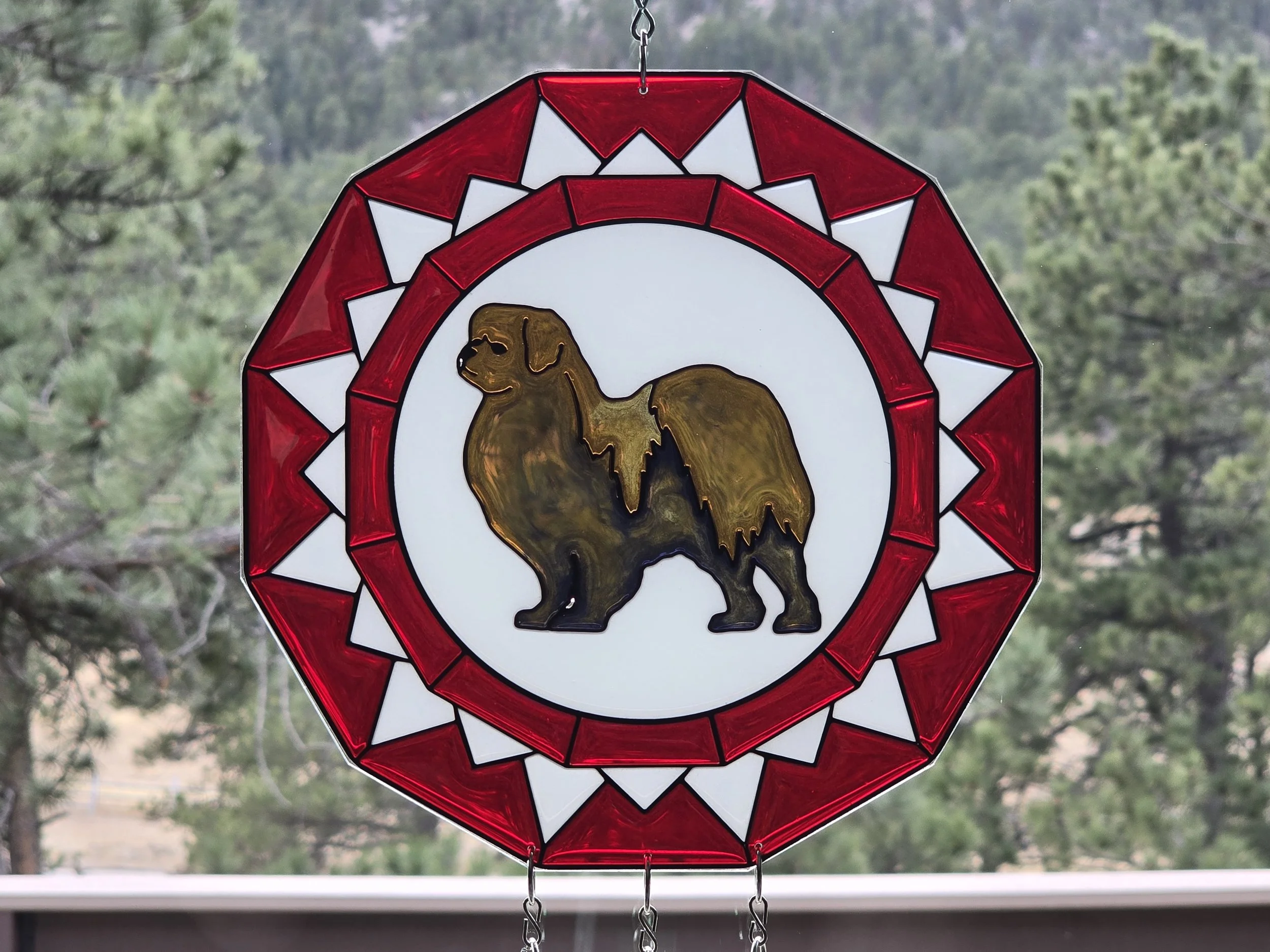 Red and white resin rosette suncatcher with a brown and black Tibetan Spaniel silhouette