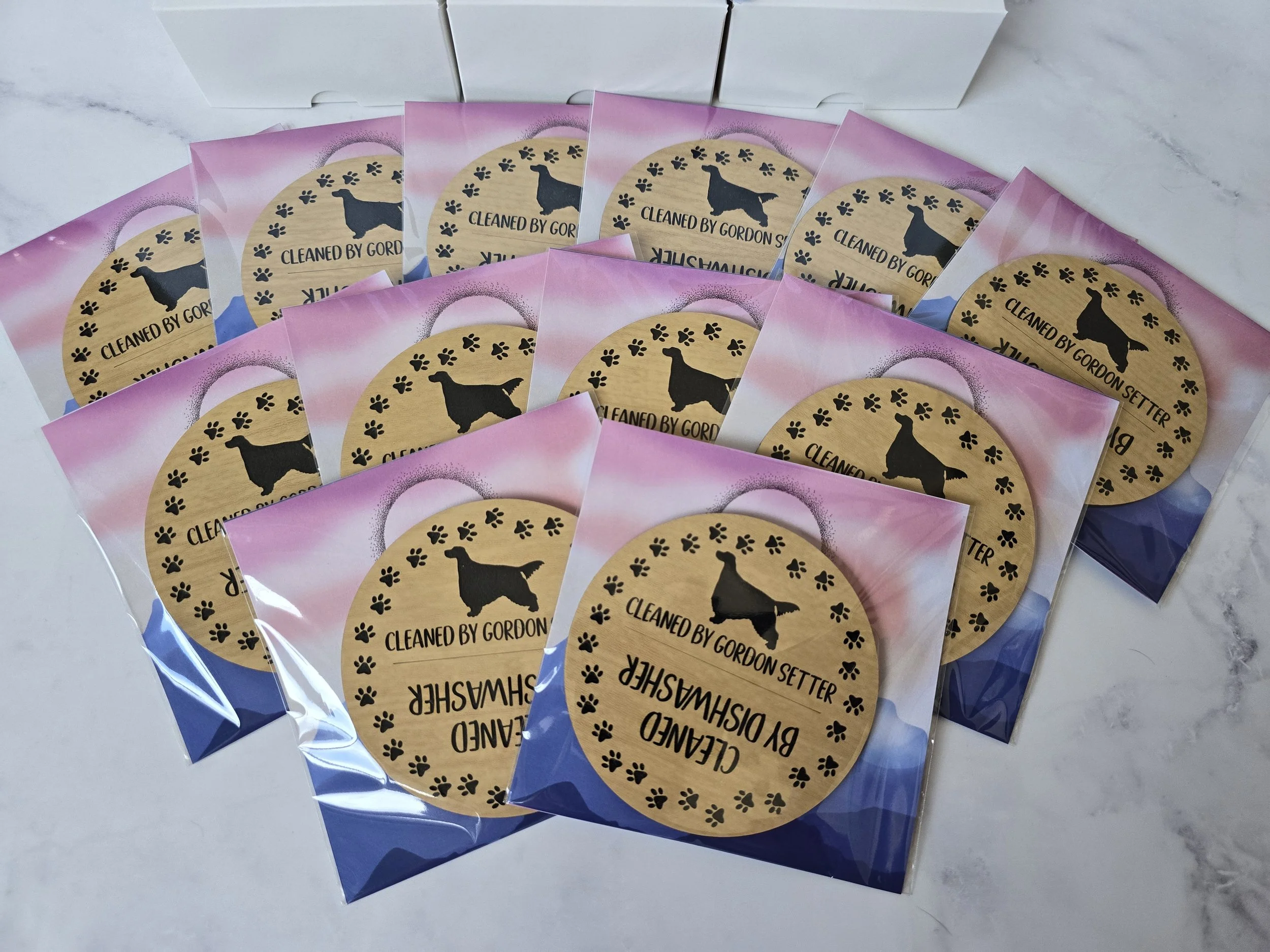 Multiple magnets featuring a design of a Gordon Setter and paw prints, labeled "Cleaned by Gordon Setter".