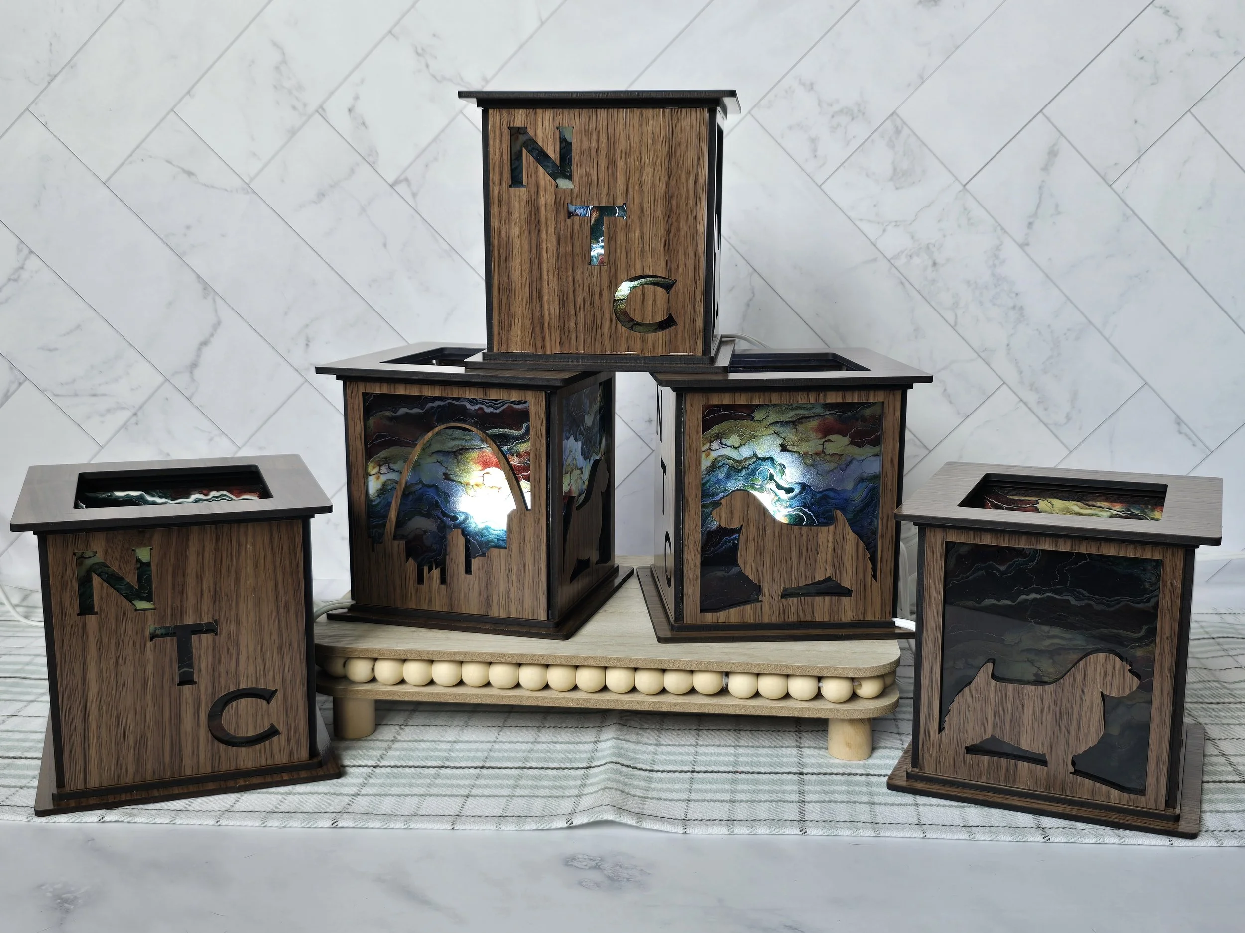 Five walnut lanterns with NTC lettering, Norwich Terrier cutouts and the Gateway Arch over acrylic