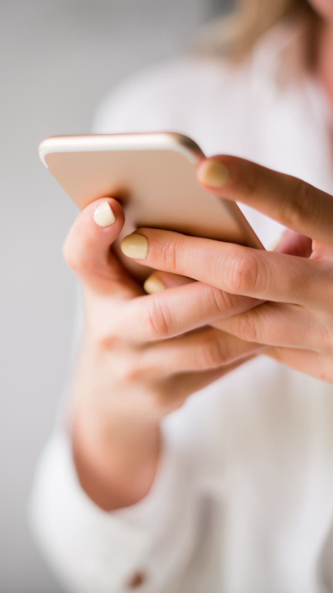 Close-up of a person's hand holding and using a smartphone.
