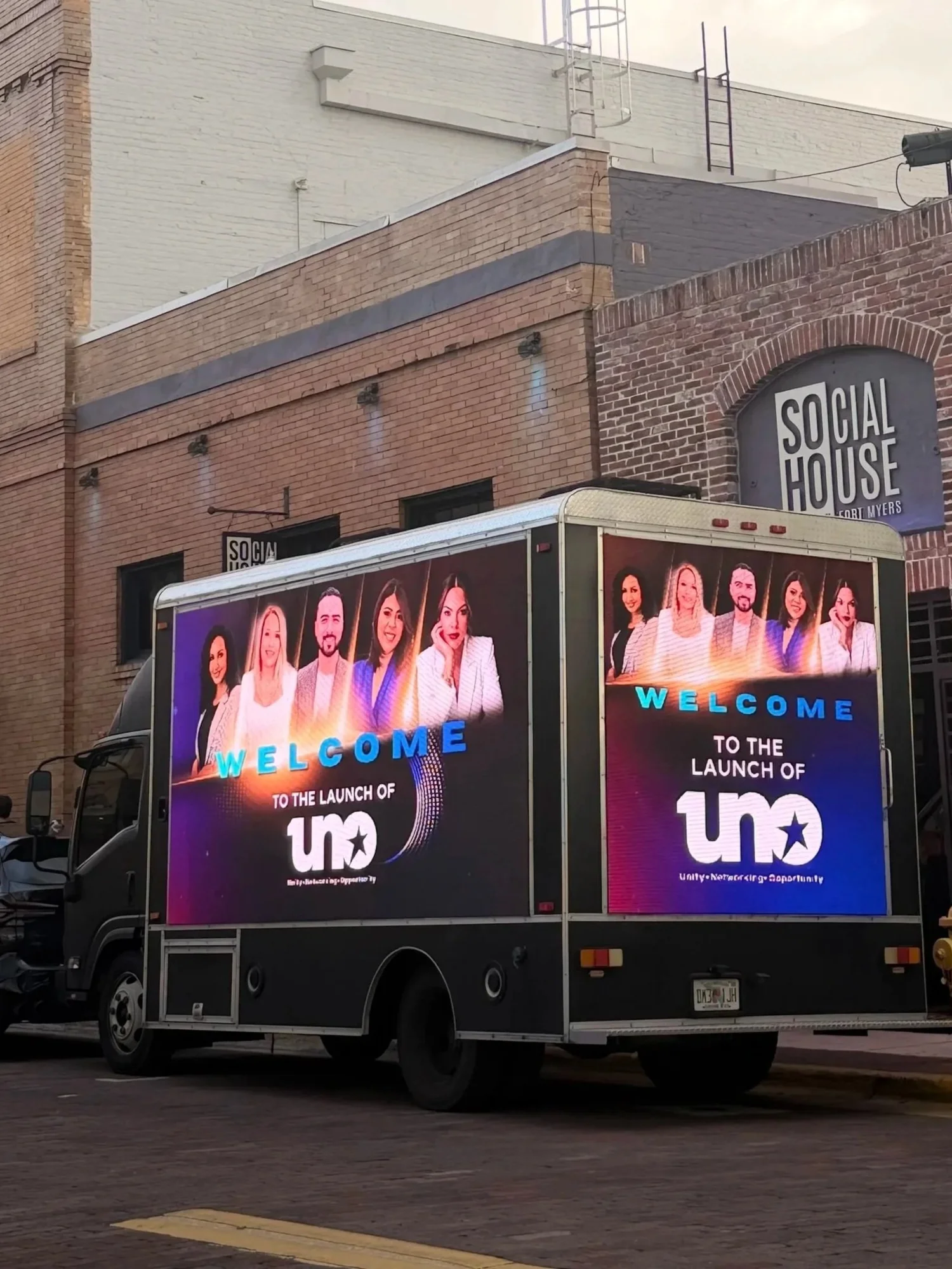LED billboard truck displaying a product launch ad outside Social House in downtown Fort Myers