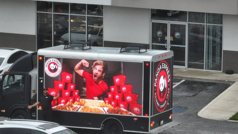 Panda Express ad on the side of the LED billboard truck parked at a shopping center