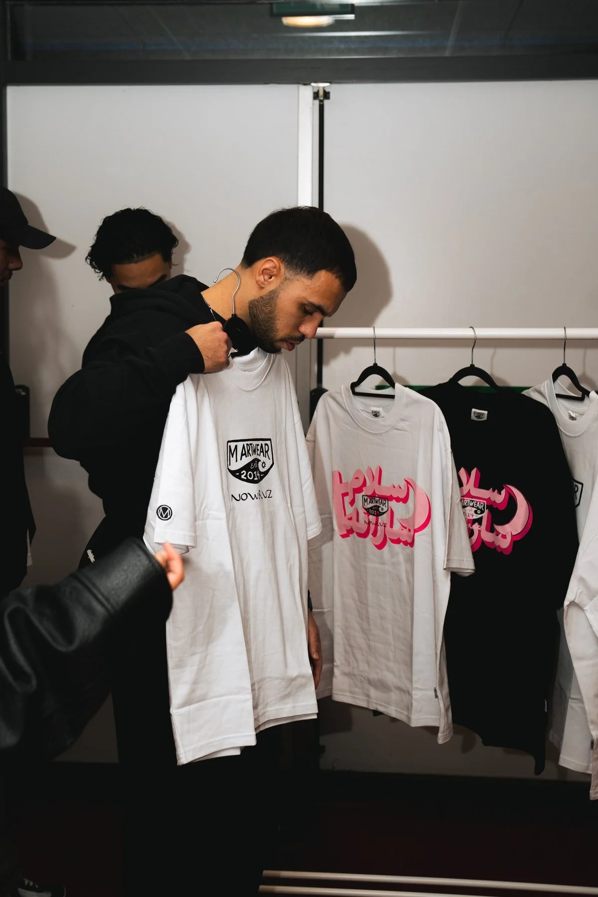 Trying on the white tee at Balai Pusat