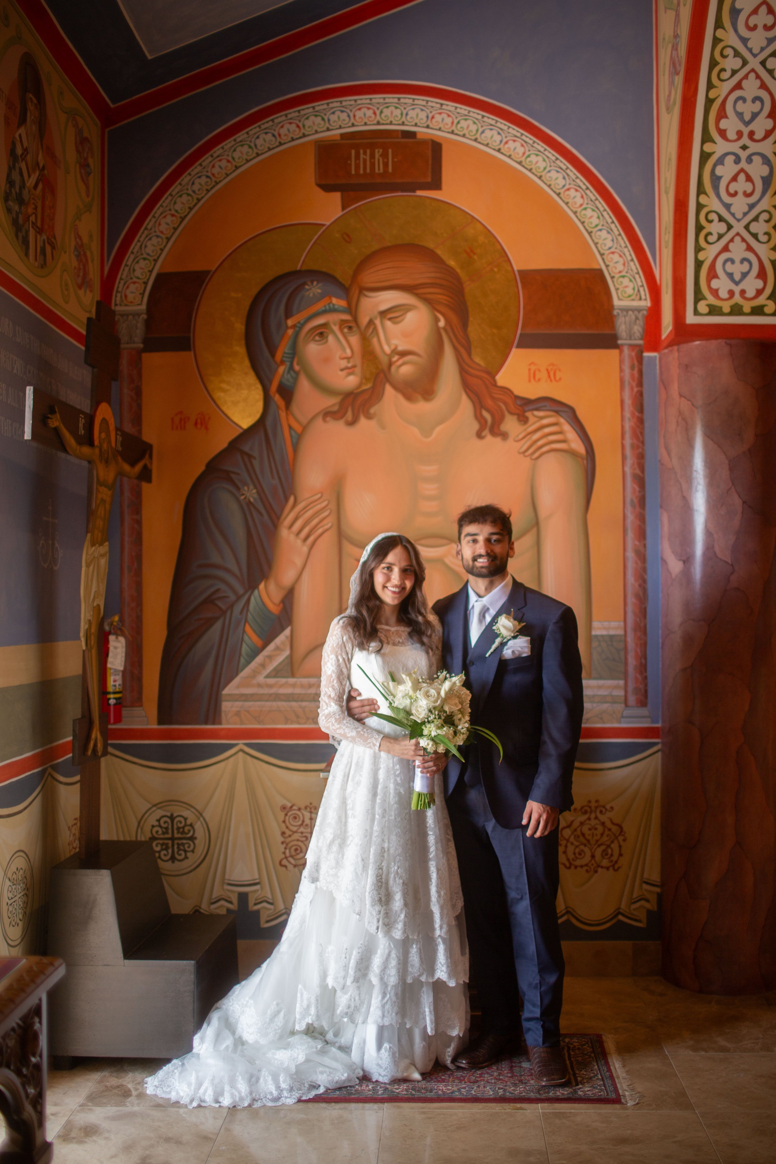 Bride and groom posed for wedding portrait at St. Joseph Orthodox Church in Houston, Texas