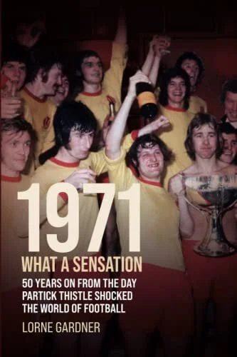 Group of people celebrating with drinks and a trophy, wearing yellow jerseys with red collars, in a dimly lit setting, marking a 50-year anniversary of a significant football event from 1971.