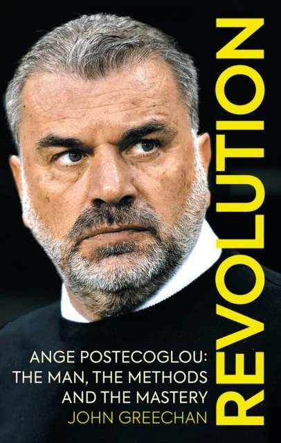 Close-up of a man with gray hair and beard, wearing a black jacket, with the word 'REVOLUTION' in large yellow letters vertically on the right, and the text 'ANGE POSTECOGLU: THE MAN, THE METHODS AND THE MASTERY JOHN GREECHAN' at the bottom.