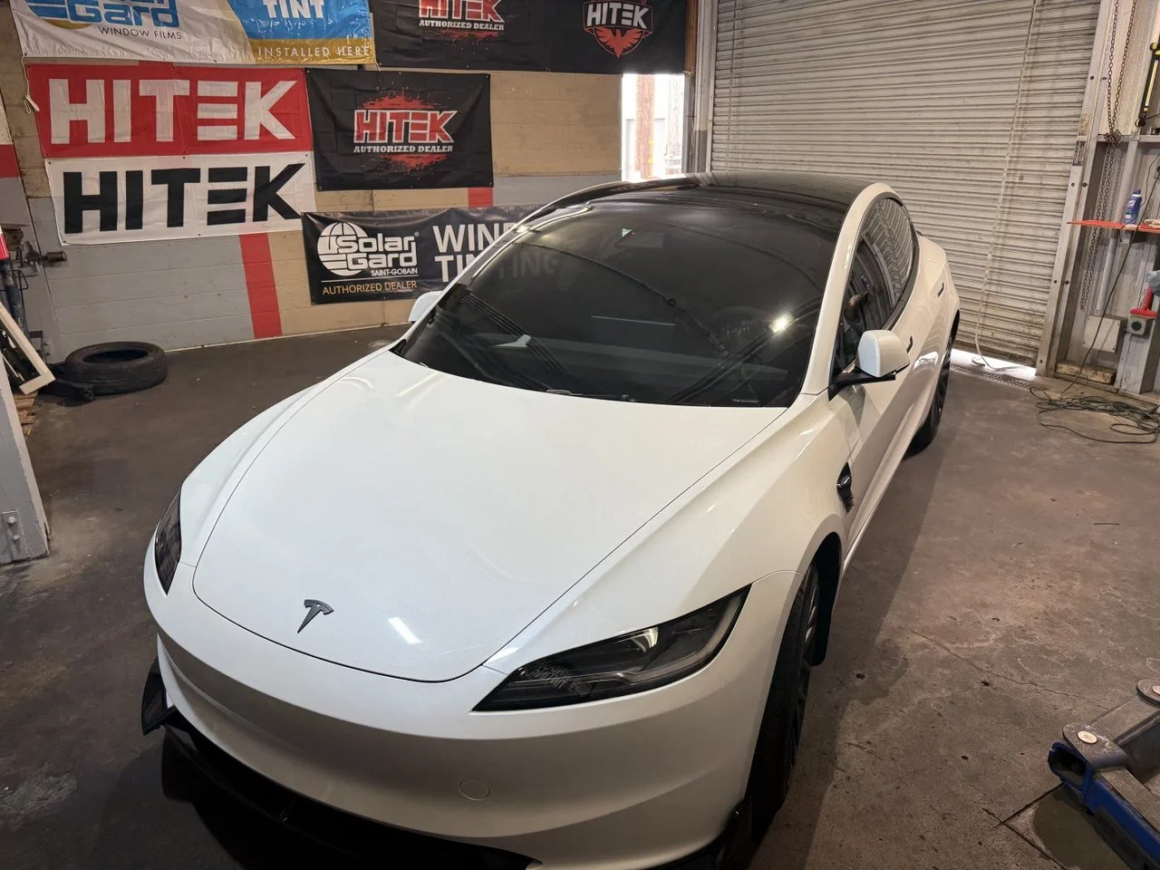 Installing ceramic IR window tint on front door glass – professional tint installation at Oceanside Tint & Glass