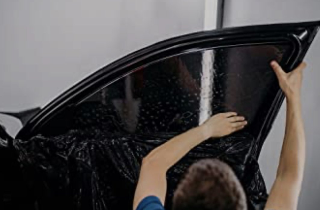 Installing ceramic IR window tint on front door glass – professional tint installation at Oceanside Tint & Glass