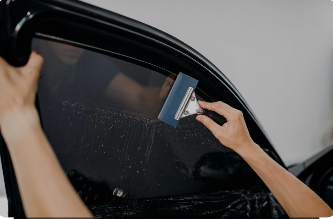 Installing ceramic IR window tint on front door glass – professional tint installation at Oceanside Tint & Glass