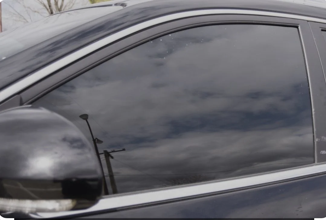 Installing ceramic IR window tint on front door glass – professional tint installation at Oceanside Tint & Glass