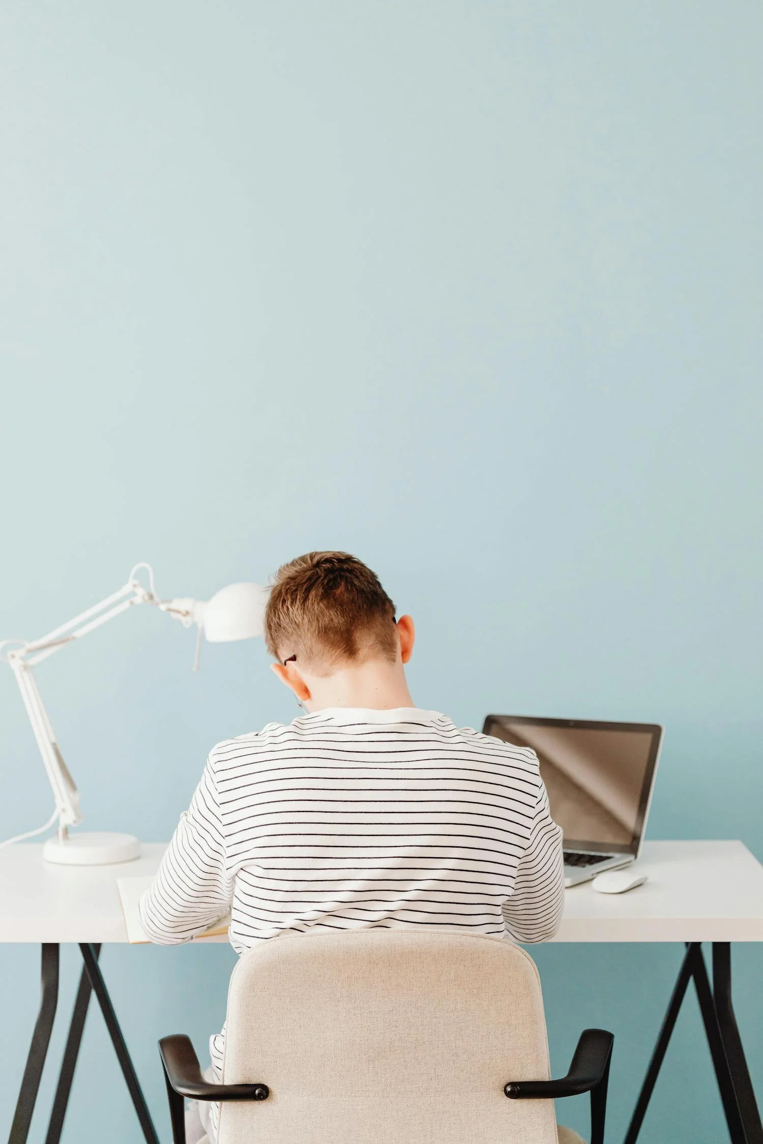 boy doing homework at desk