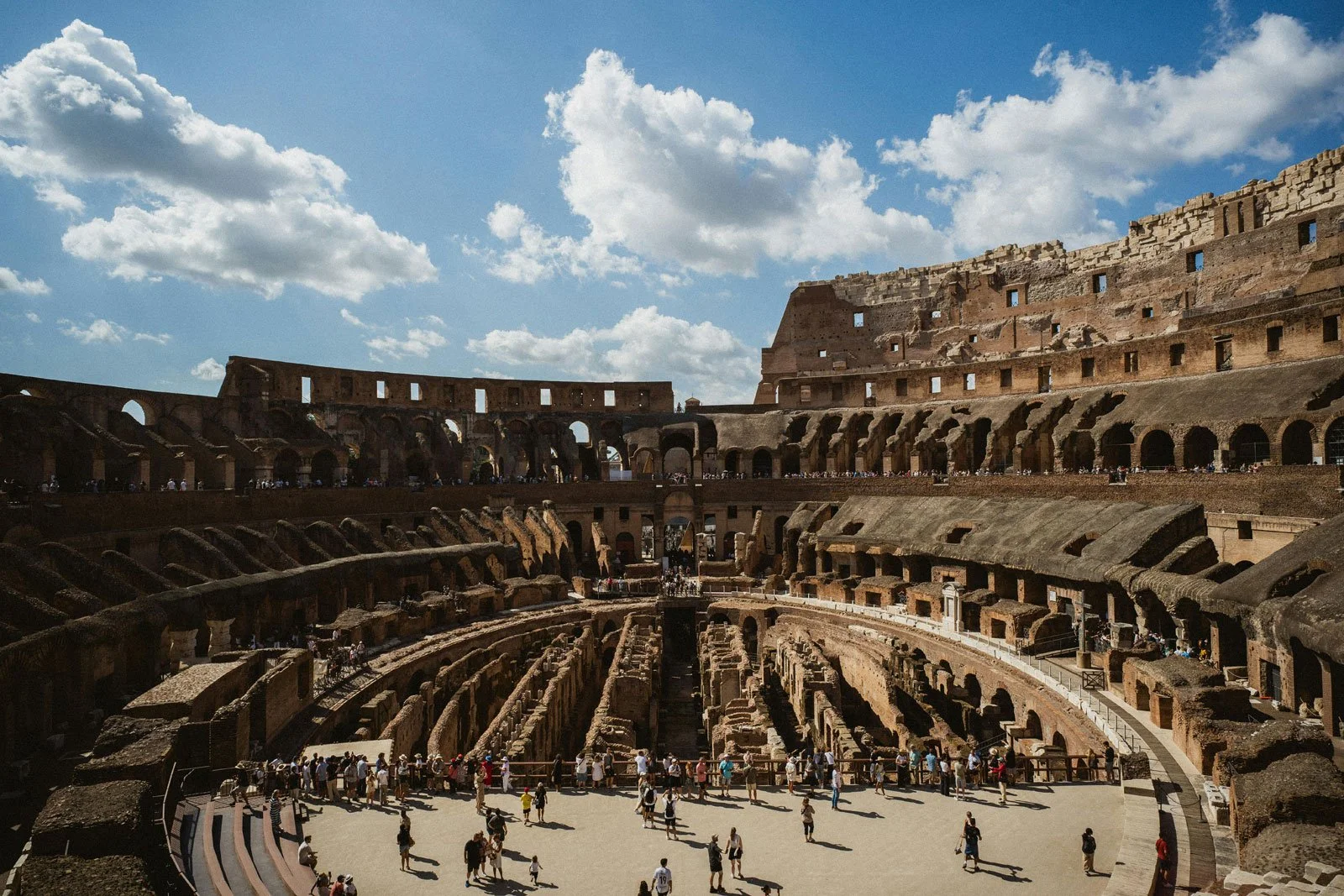 Interior view of the Colosseum showing the seating levels and the exposed hypogeum below the missing arena floor.