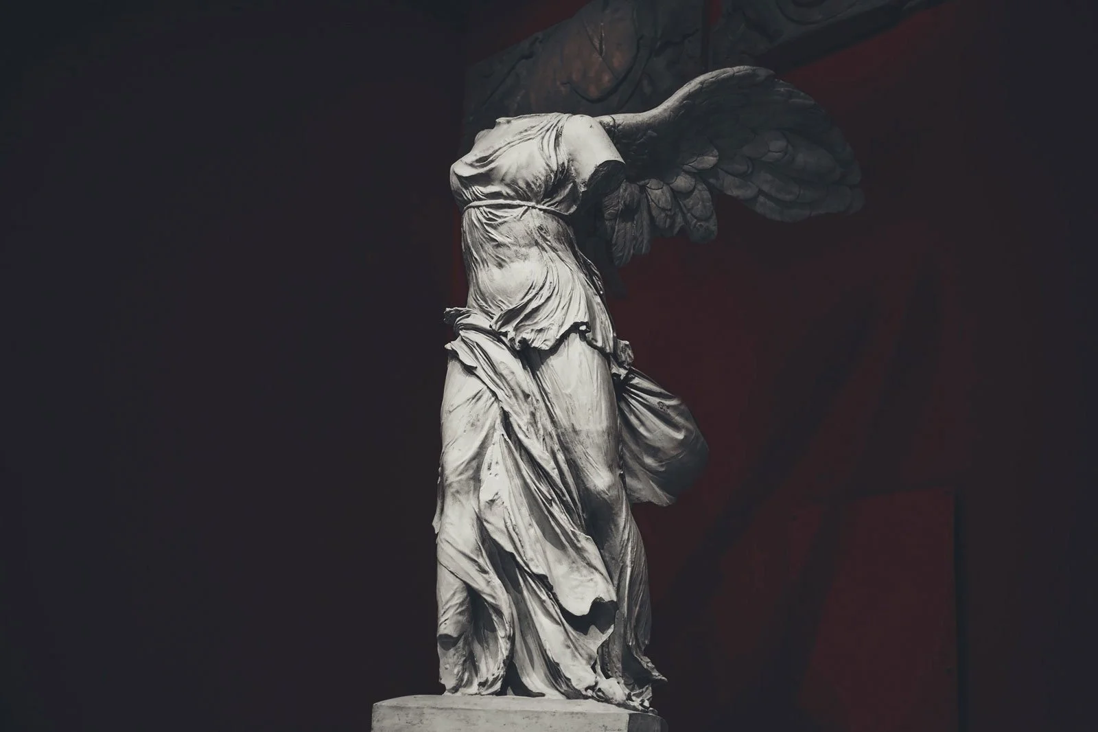 Marble statue of the Winged Victory of Samothrace with sweeping drapery and one preserved wing.