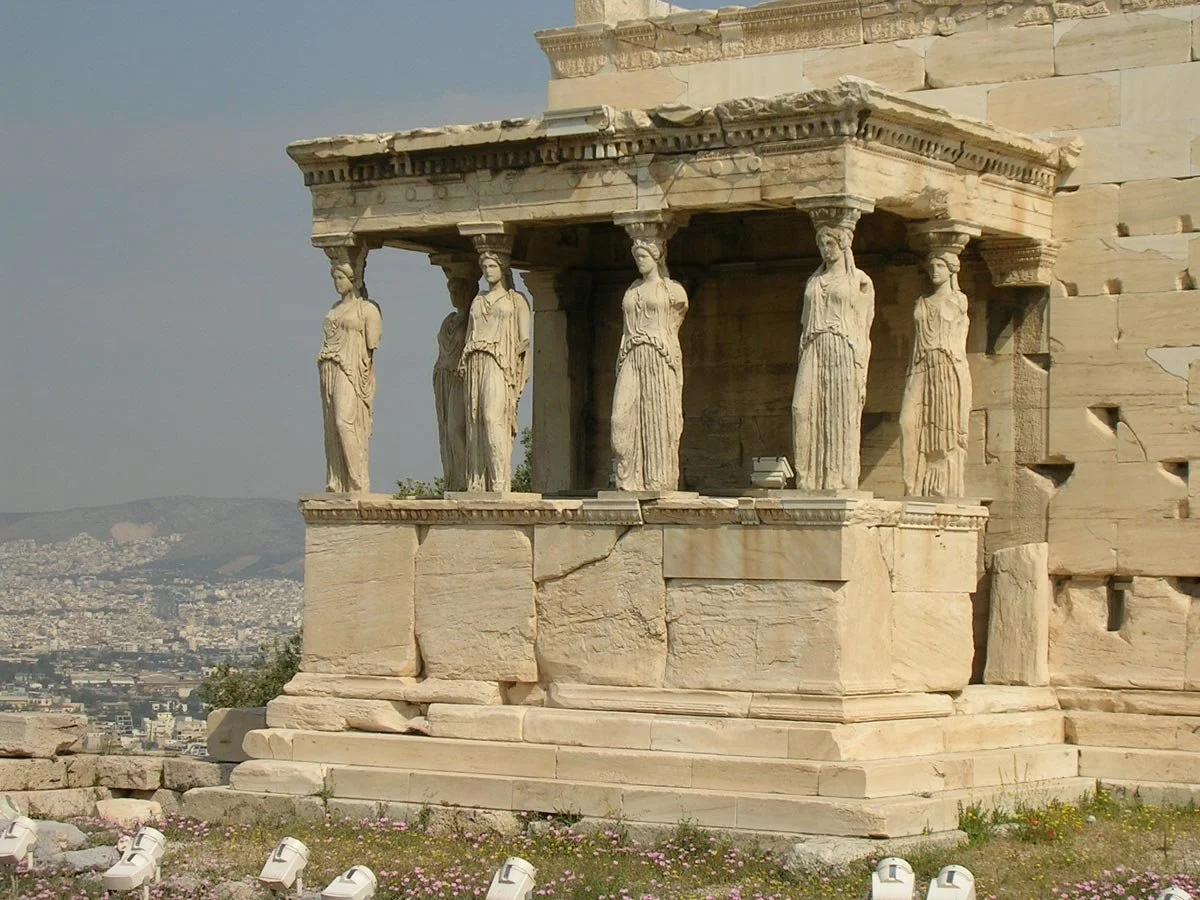 Porch of the Caryatids on the Erechtheion, six draped female figures replacing columns and overlooking Athens.
