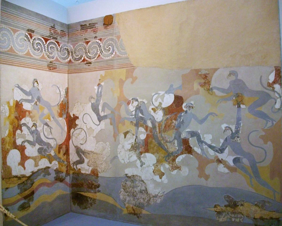 Akrotiri wall painting of blue monkeys leaping among rocks and plants beneath a spiral frieze.