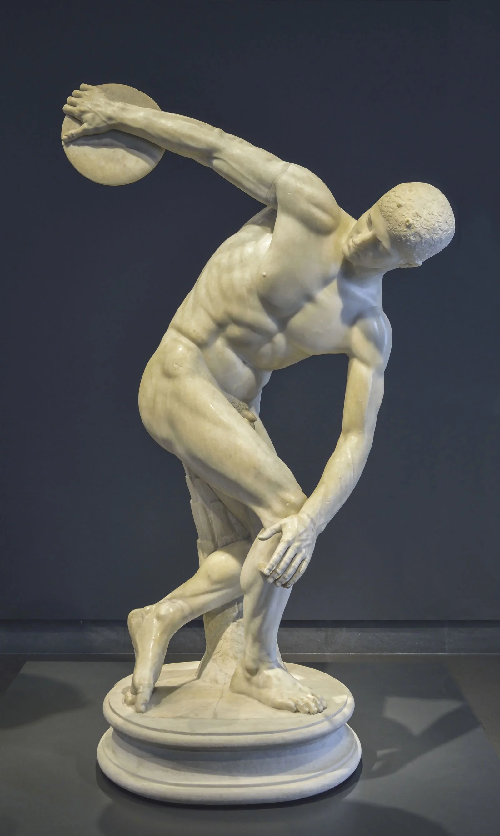 Roman marble copy of the Discobolus shown in a museum gallery.
