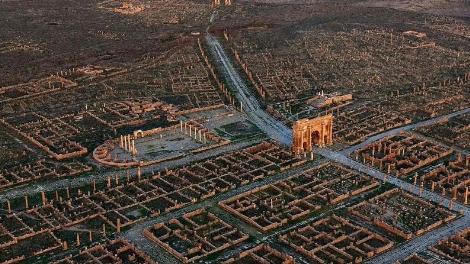 Aerial view of Timgad showing a Roman street grid, monuments, and the main axes of the city.
