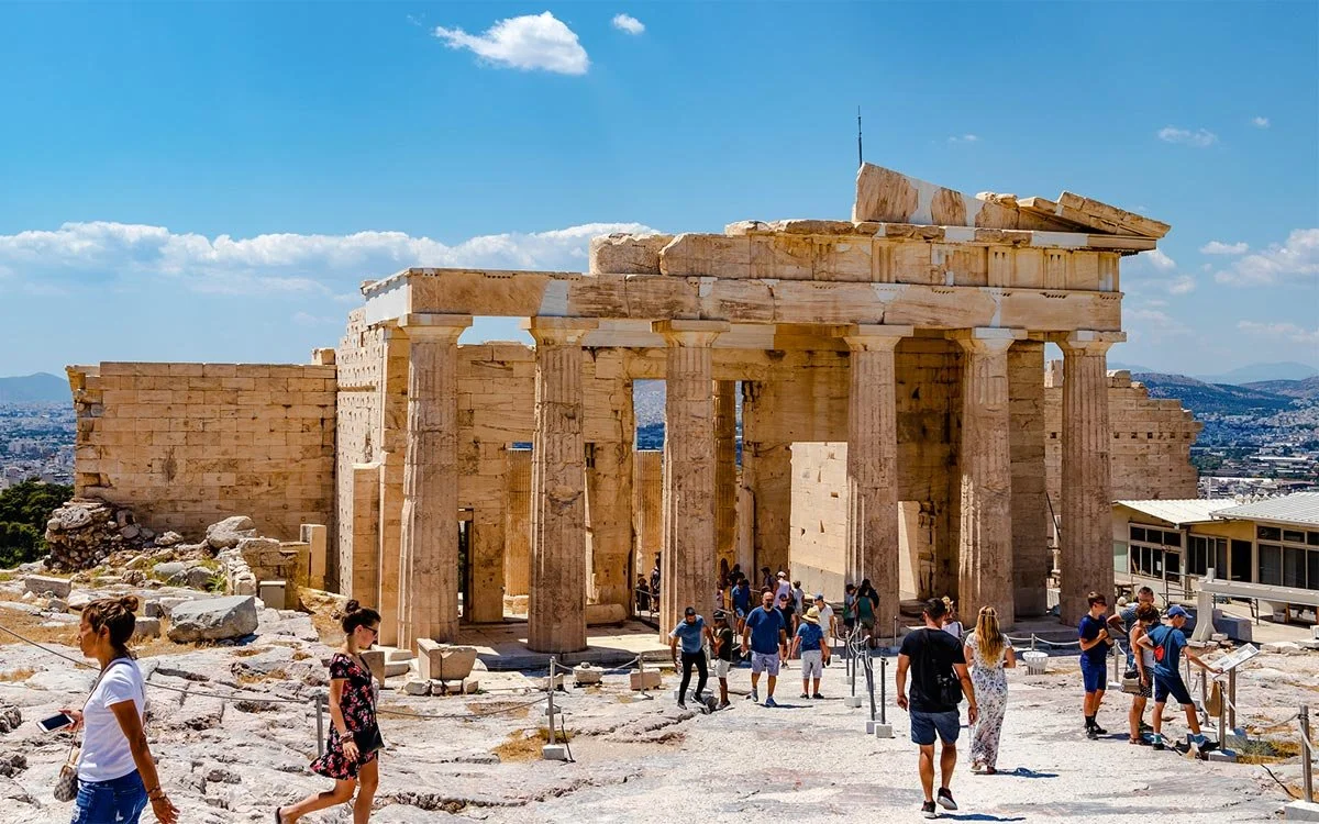 Visitors walking through the Propylaea entrance to the Acropolis in Athens.