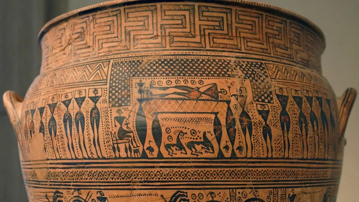 Geometric Dipylon-style krater with meander bands and a central funeral scene framed by mourners, animals and patterned friezes.