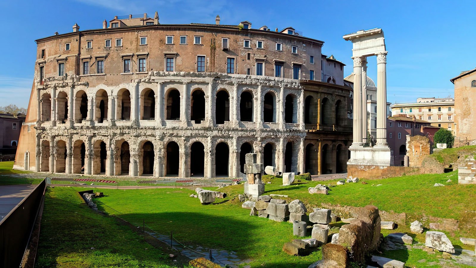 Exterior view of the Theatre of Marcellus with stacked rows of Roman arches.