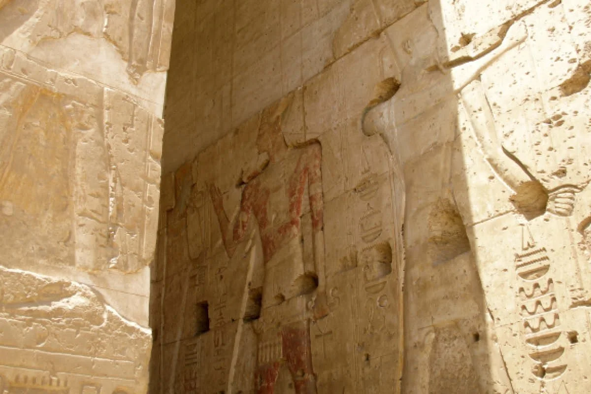 Carved and painted wall relief of Seti I at Abydos with hieroglyphic inscriptions.