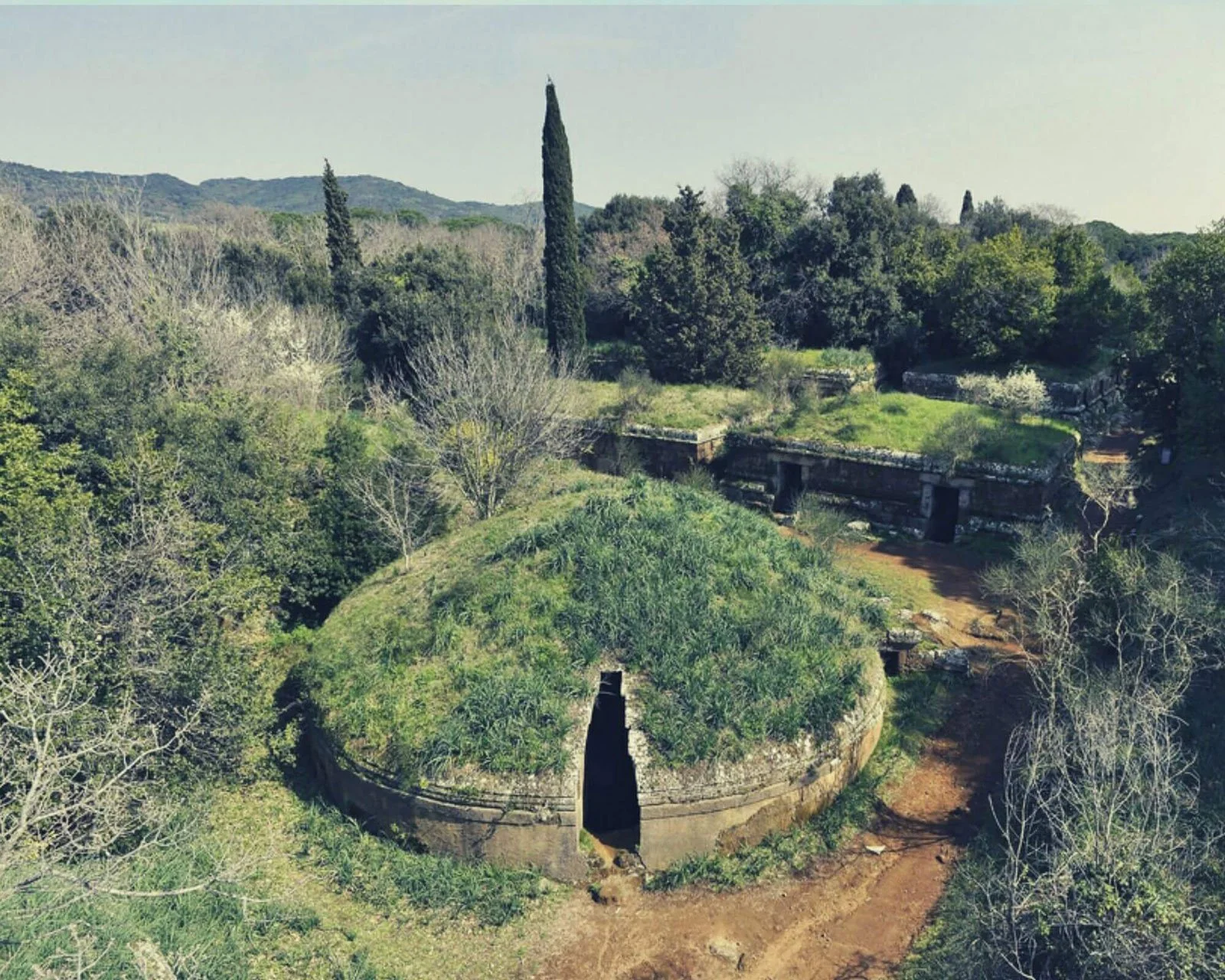 Wide view of the Banditaccia Necropolis with tomb structures spread across an open landscape.