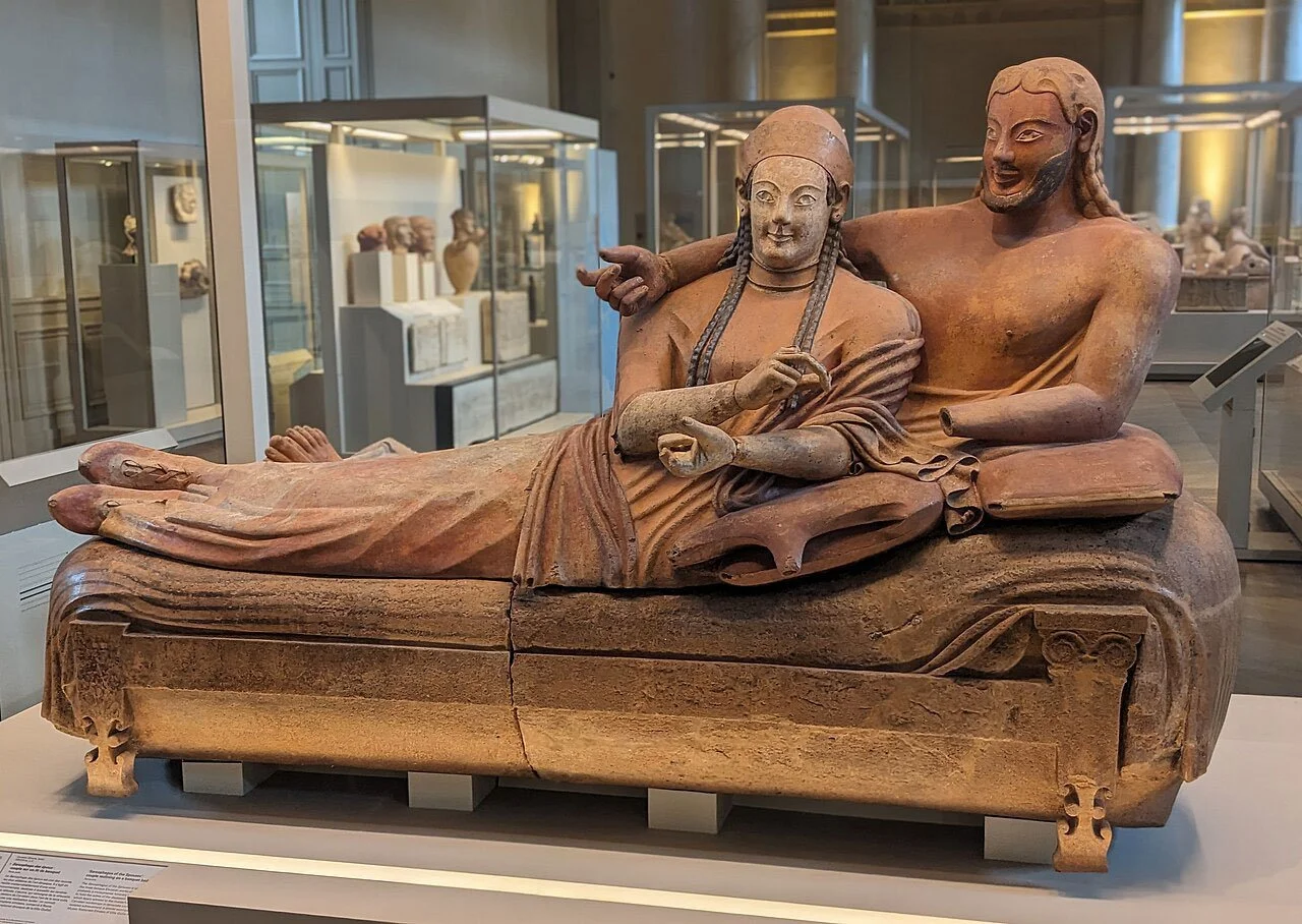 Full view of the Louvre Sarcophagus of the Spouses with the reclining couple on a banqueting couch.
