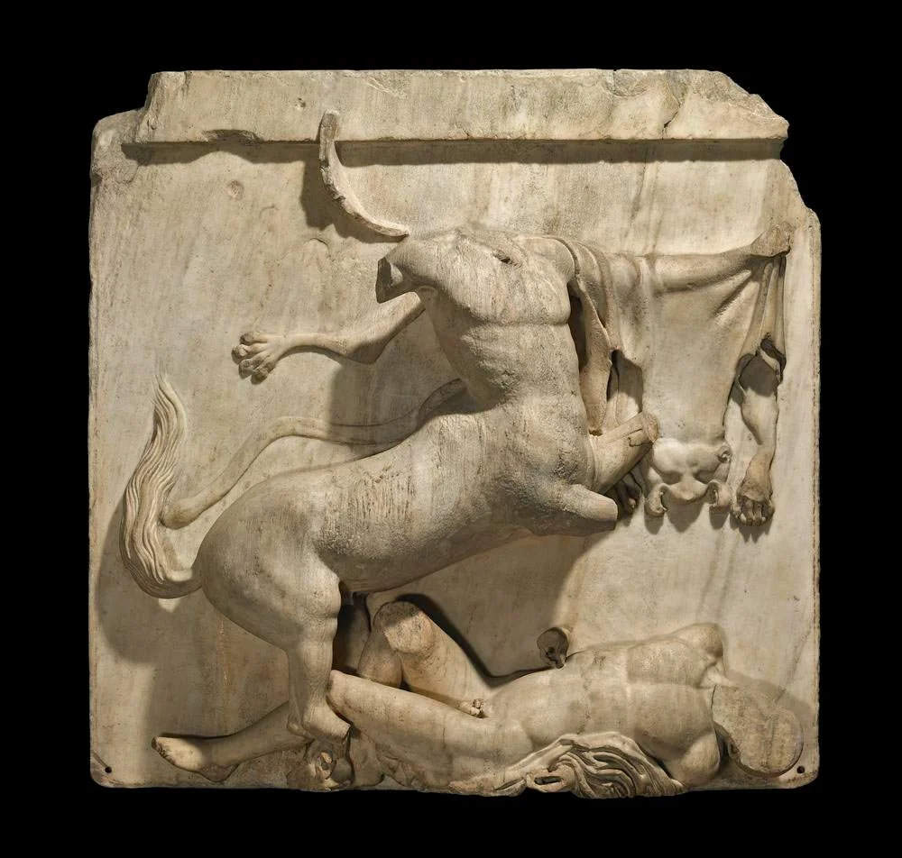 Marble metope with a centaur rearing over a fallen human figure.