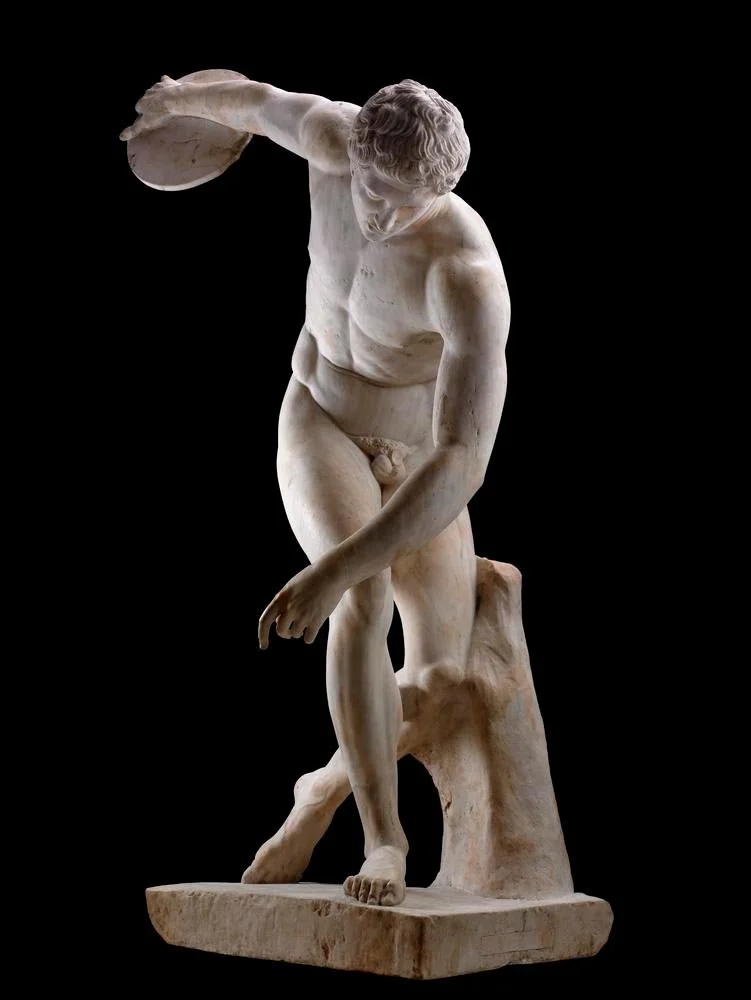 Marble copy of the Discobolus isolated against a dark background.