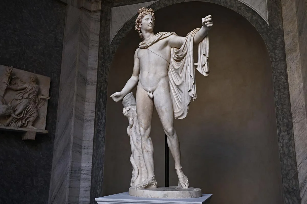 Marble statue of Apollo standing in an idealized contrapposto pose.