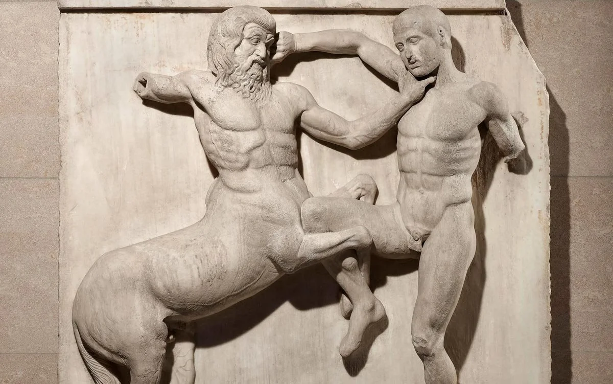 Marble relief of a centaur grappling with a human figure in a dramatic struggle.