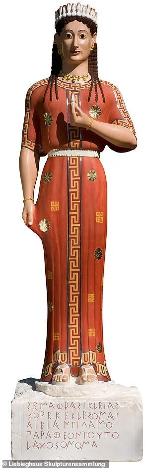 Modern painted reconstruction of the Peplos Kore with red dress and patterned details.