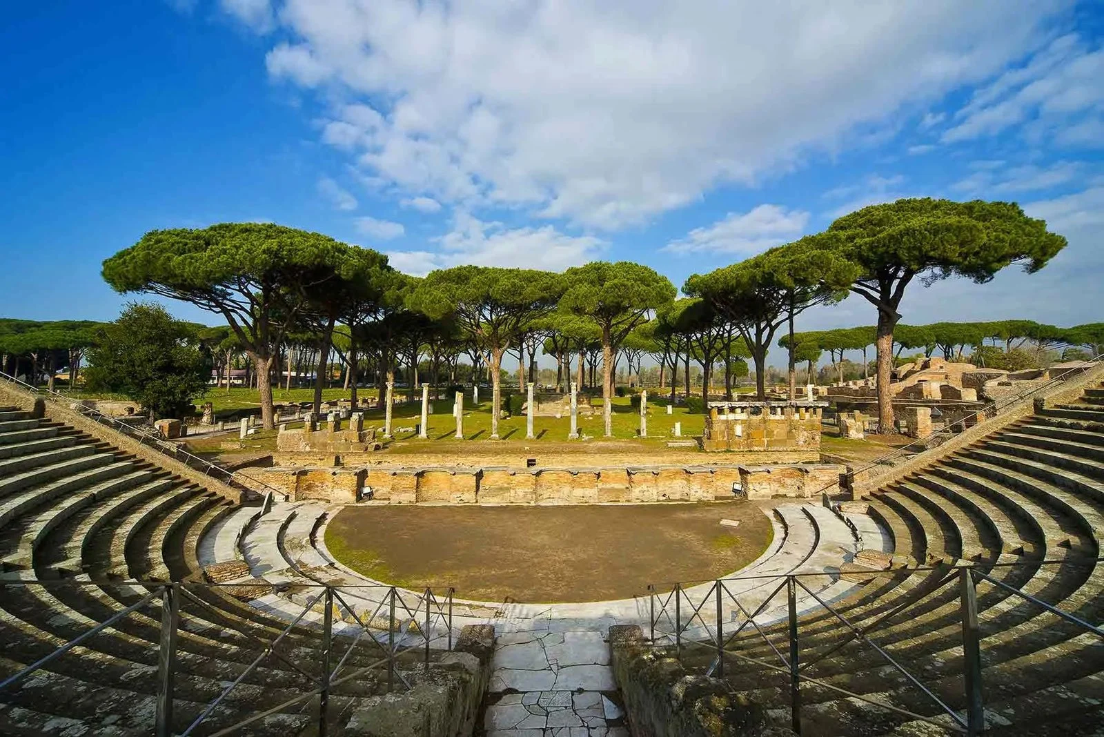 Brick Roman building at Ostia Antica with arched openings and a curved exterior wall.