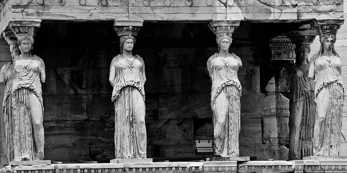 Black and white view of the Erechtheion’s porch of the Caryatids, six draped maidens acting as supports on the Athenian Acropolis.