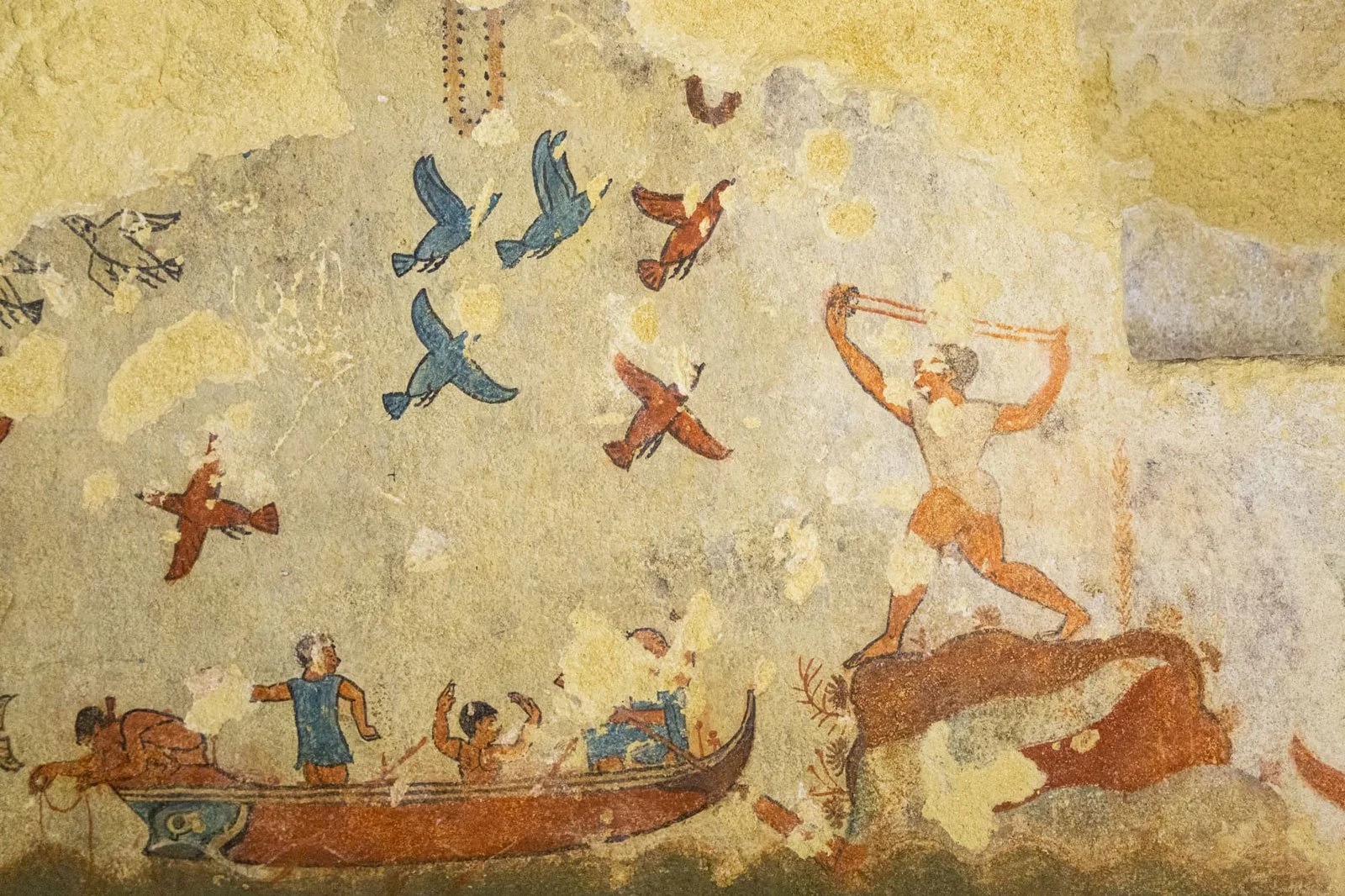 Painted wall detail from the Tomb of Hunting and Fishing showing a hunter, birds, and a boat scene.