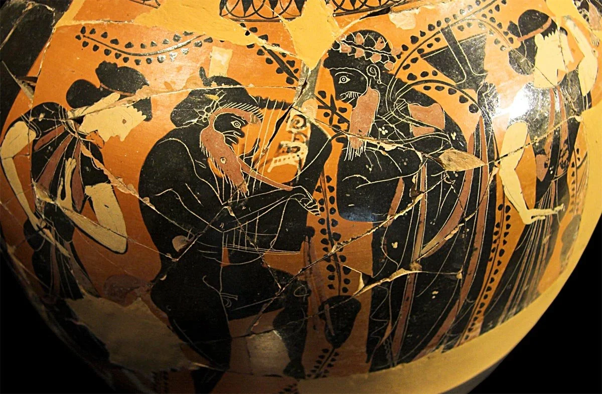 Black-figure vessel with Dionysos, satyr playing the lyre and maenads, figures picked out in added red and white details.