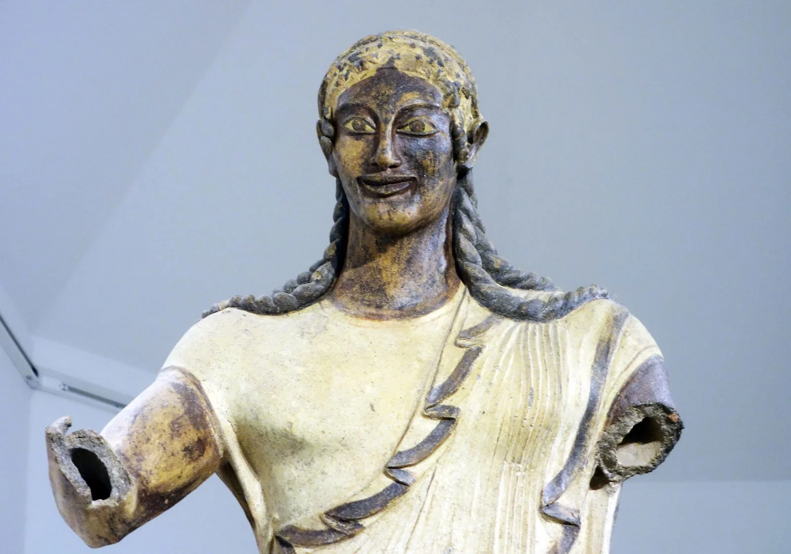 Terracotta statue of Apollo of Veii with an Archaic smile and forward stride.
