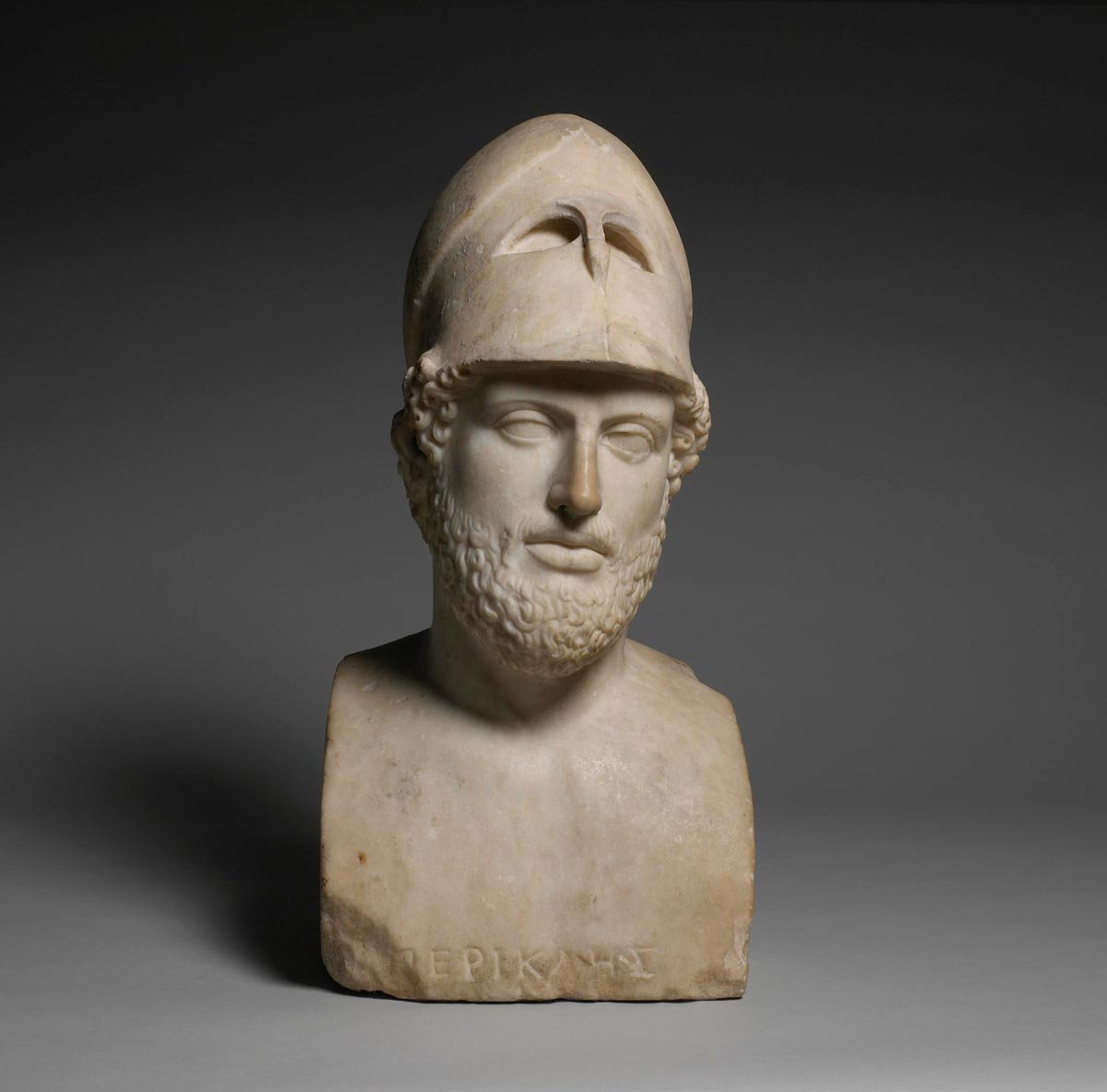 Marble portrait bust of Pericles wearing a crested helmet and a full beard.
