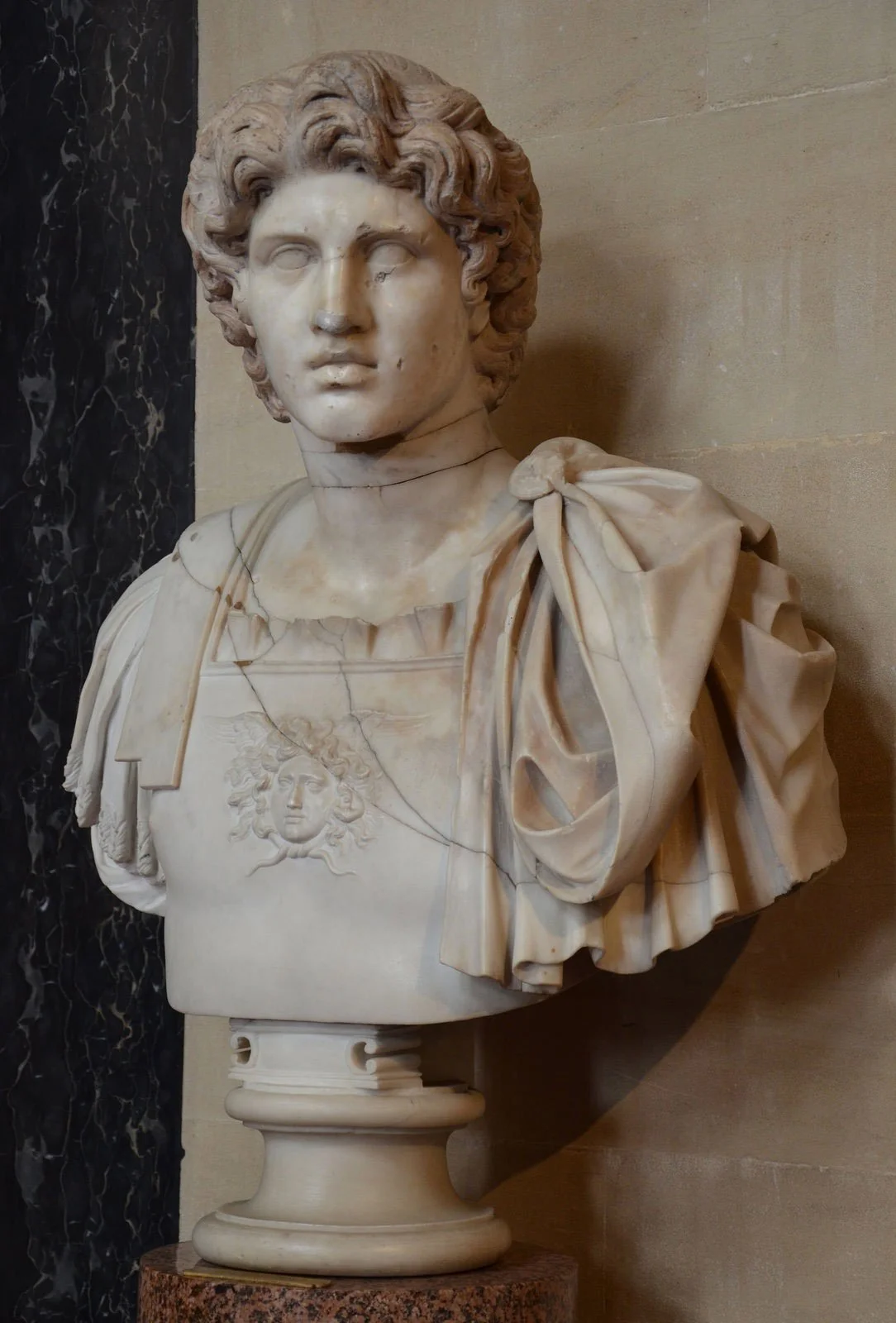 Marble bust of Alexander the Great in armor with thick wavy hair.