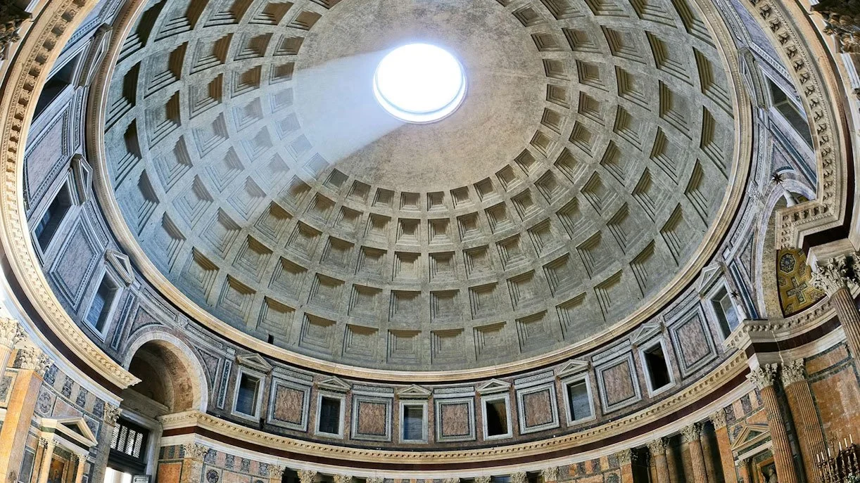 Interior view of the Pantheon dome with the oculus and a beam of light entering the space.