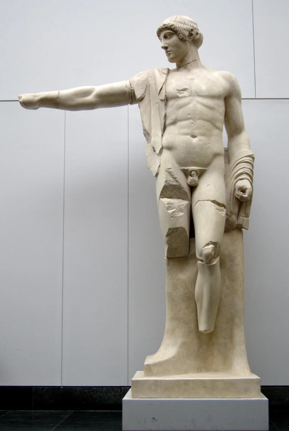 Marble Apollo figure with one arm extended, based on the west pediment composition at Olympia.