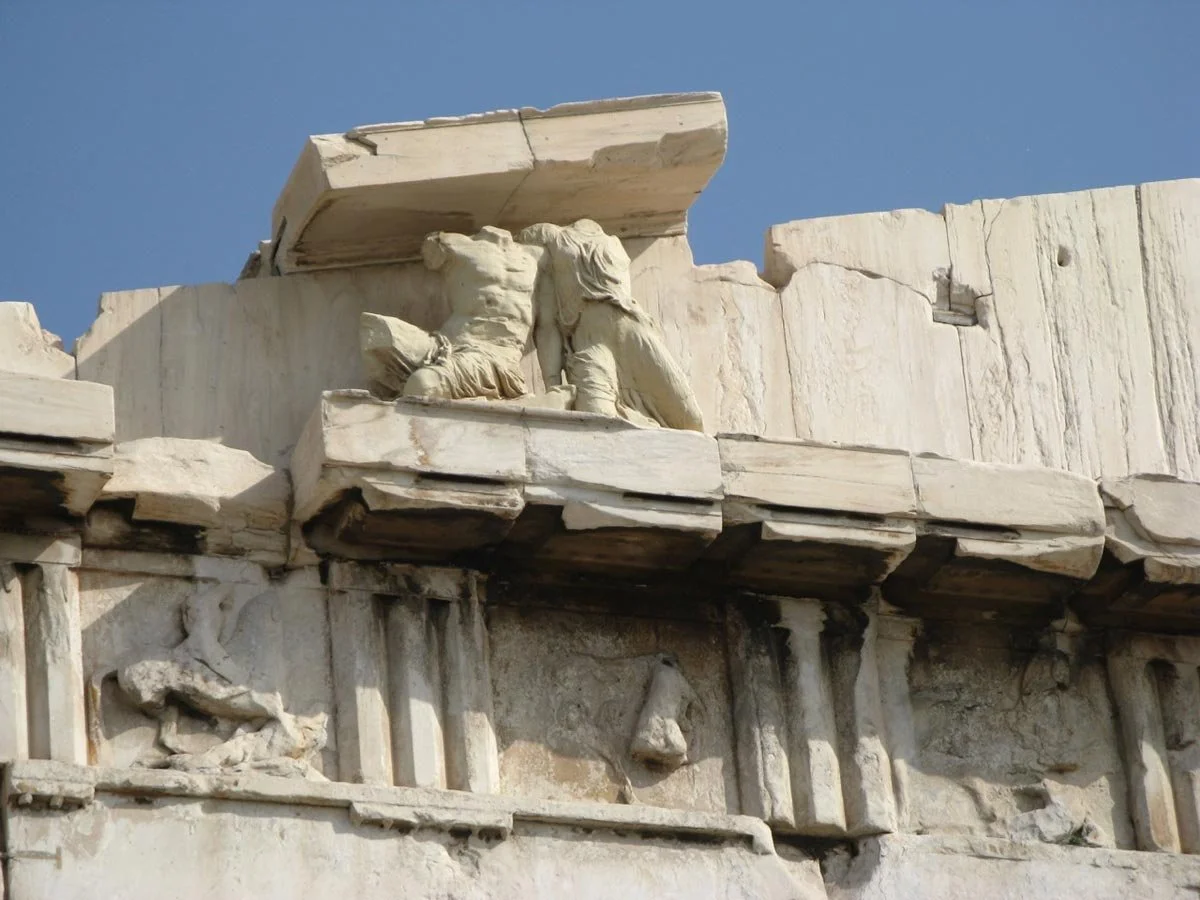 Close view of the Parthenon entablature showing sculptural remains above the Doric frieze.