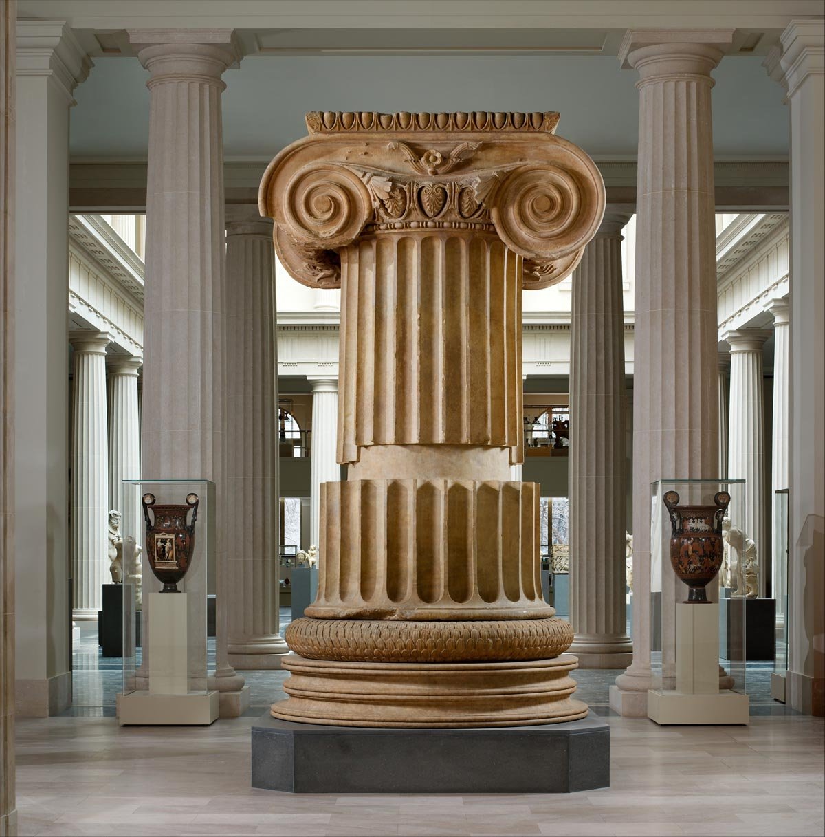 Colossal Ionic column section from the Temple of Artemis at Sardis, its tall fluted shaft and rich volute capital dominating the gallery.