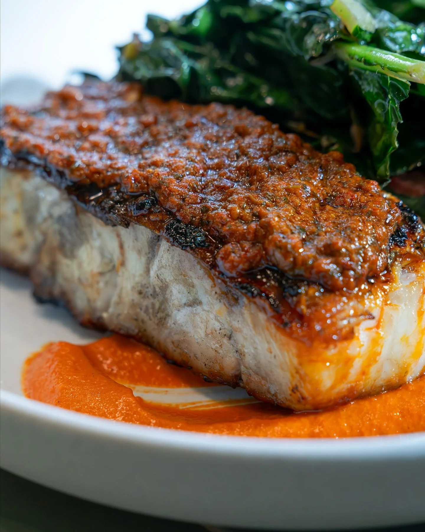 Barramundi (Australian sea bass) with romesco, harissa, tuscan kale, and swiss chard. Light, smoky, and full of flavor.