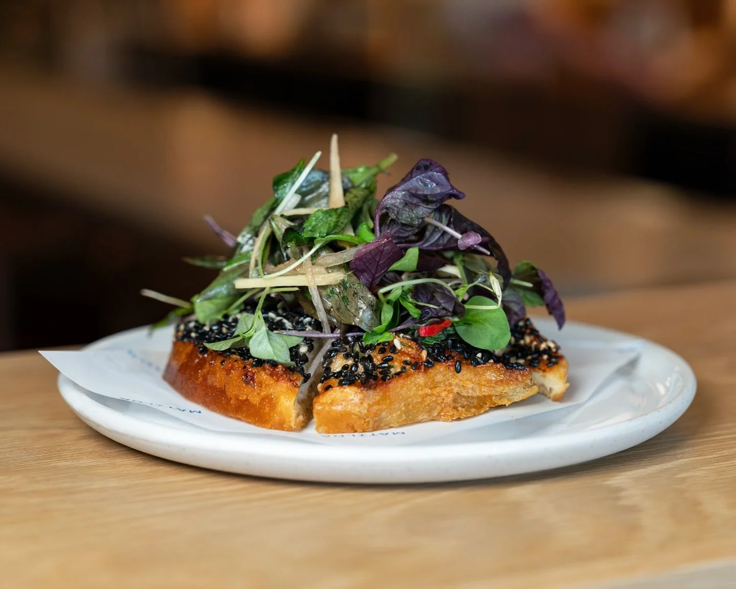 Prawn toast, finished with an Asian herb salad and sesame lime dressing.