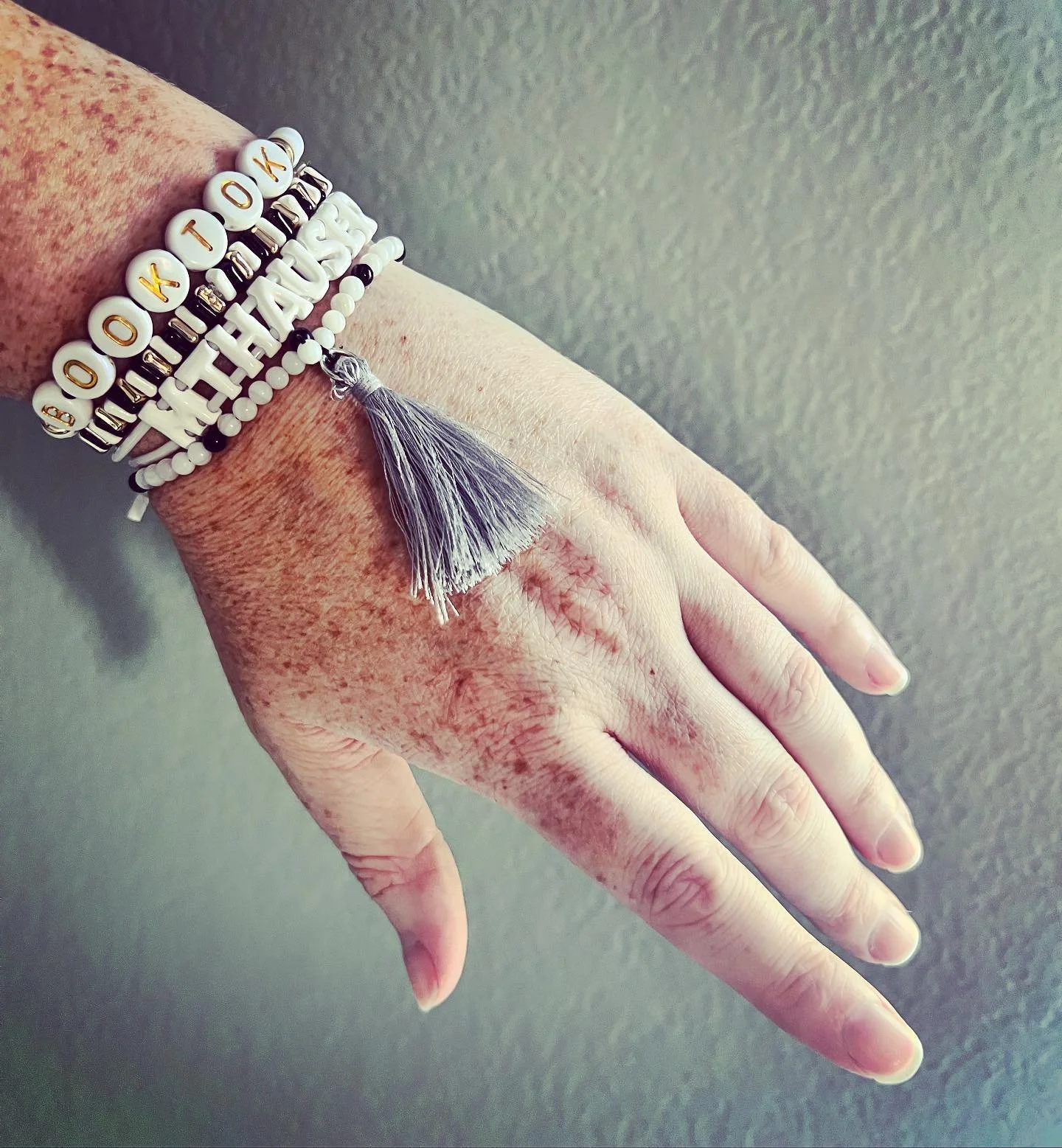 &ldquo;Freckled hands are the sign of an outdoor reader.&rdquo; #MTHauser #books #bookstagram #book #booklover #reading #booktok #bookstagrammer #read #bookish #booknerd #bookaddict #booksofinstagram #bibliophile #bracelet #bracelets #love #bookshelf